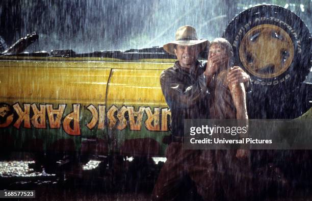 Sam Neill covers the mouth of Ariana Richards in a scene from the film 'Jurassic Park', 1993.