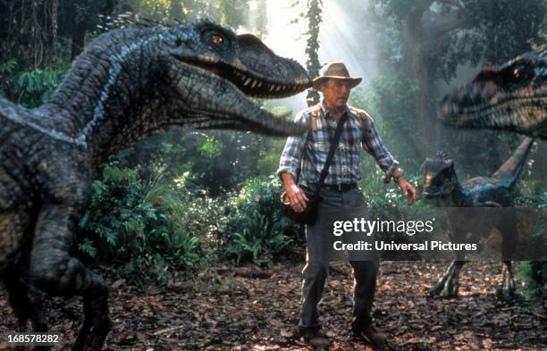 Sam Neill is confronted by three dinosaurs in a scene from the film 'Jurassic Park III', 2001.
