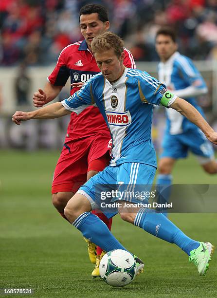 Brian Carroll of the Philadelphia Union controls the ball under pressure from Dilly Duka of the Chicago Fire during an MLS match at Toyota Park on...