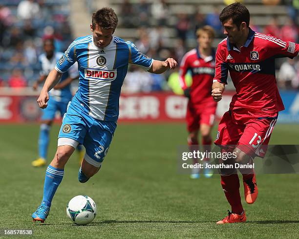 Antoine Hoppenot of the Philadelphia Union controls the ball chased by Gonzalo Segares of the Chicago Fire during an MLS match at Toyota Park on May...