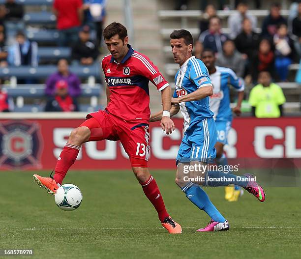 Gonzalo Segares of the Chicago Fire passes the ball in front of Sebastien Le Toux of the Philadelphia Union during an MLS match at Toyota Park on May...