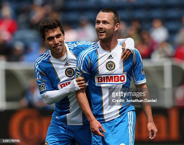 Jack McInerney and Michael Farfan of the Philadelphia Union celebrate McInerney's game winning goal against Chicago Fire during an MLS match at...