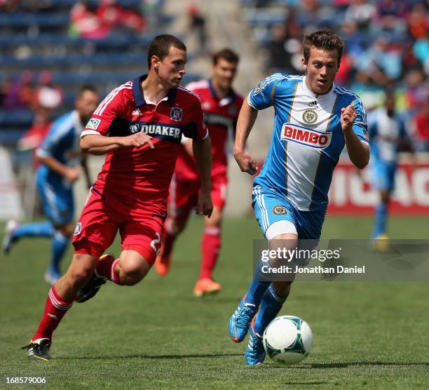 Antoine Hoppenot of the Philadelphia Union controls the ball chased by Austin Berry of the Chicago Fire during an MLS match at Toyota Park on May 11,...