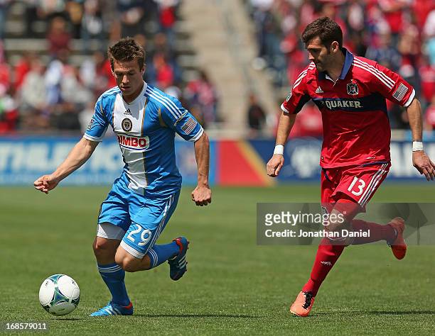 Antoine Hoppenot of the Philadelphia Union controls the ball chased by Gonzalo Segares of the Chicago Fire during an MLS match at Toyota Park on May...
