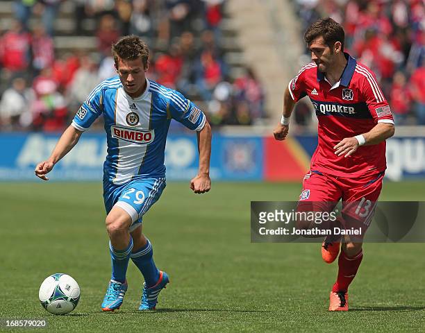 Antoine Hoppenot of the Philadelphia Union controls the ball chased by Gonzalo Segares of the Chicago Fire during an MLS match at Toyota Park on May...