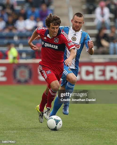 Wells Thompson of the Chicago Fire charges up the field chased by Jack McInerney of the Philadelphia Union during an MLS match at Toyota Park on May...