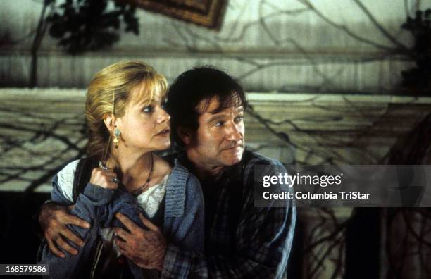 Bonnie Hunt is held by Robin Williams in a scene from the film 'Jumanji', 1995.