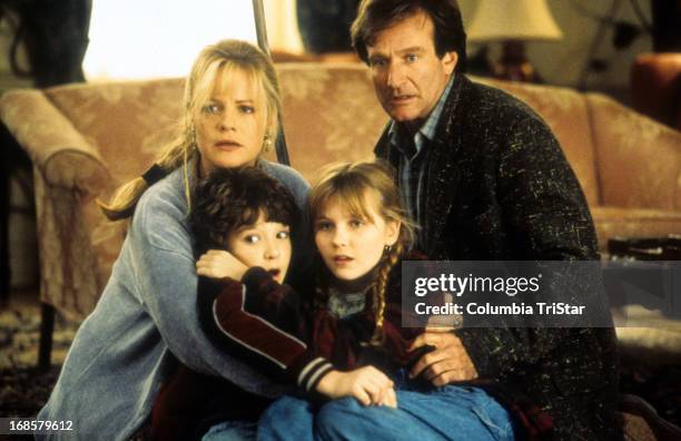 Bonnie Hunt, Bradley Pierce, Kirsten Dunst and Robin Williams hold each other in a scene from the film 'Jumanji', 1995.