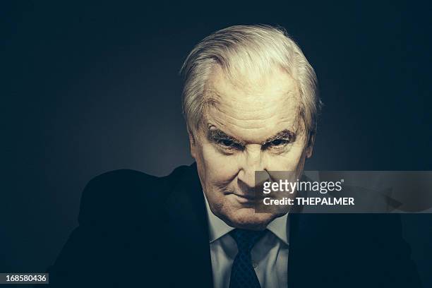 spooky senior businessman - cruel stock pictures, royalty-free photos & images