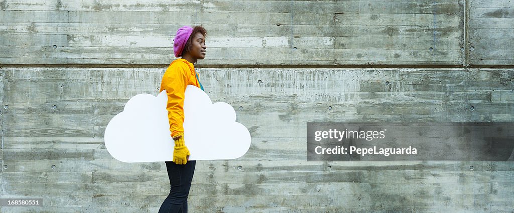 Cloud computing: young woman in urban scene