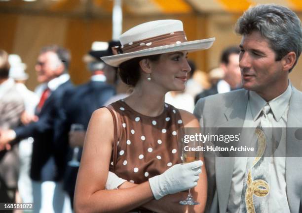 Julia Roberts has a drink with Richard Gere in a scene from the film 'Pretty Woman', 1990.