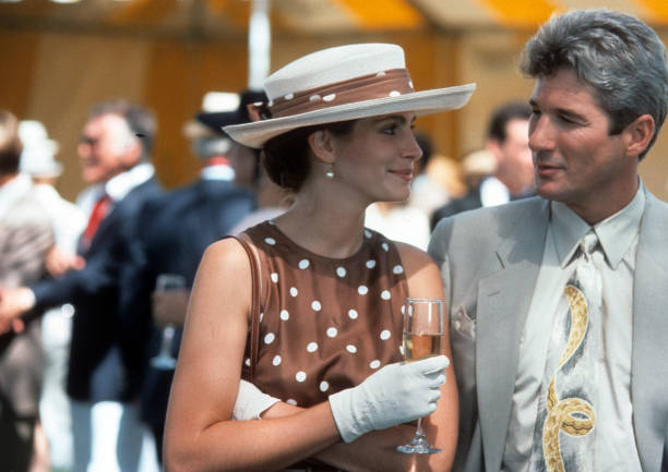 Julia Roberts has a drink with Richard Gere in a scene from the film 'Pretty Woman', 1990.