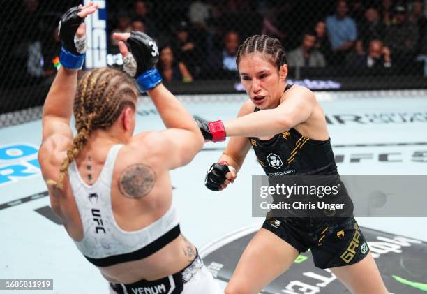 Alexa Grasso of Mexico punches Valentina Shevchenko of Kyrgyzstan in the UFC flyweight championship fight during the Noche UFC event at T-Mobile...