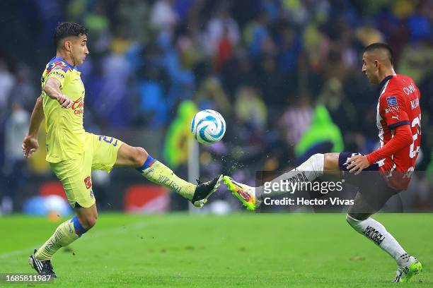 Luis Fuentes of America battles for possession with Roberto Alvarado of Chivas during the 8th round match between America and Chivas as part of the...