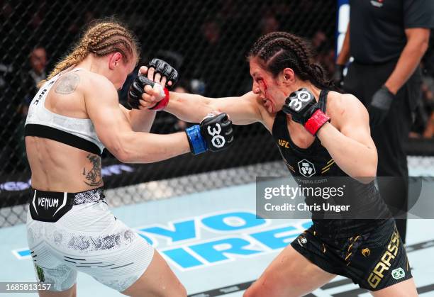 Alexa Grasso of Mexico punches Valentina Shevchenko of Kyrgyzstan in the UFC flyweight championship fight during the Noche UFC event at T-Mobile...