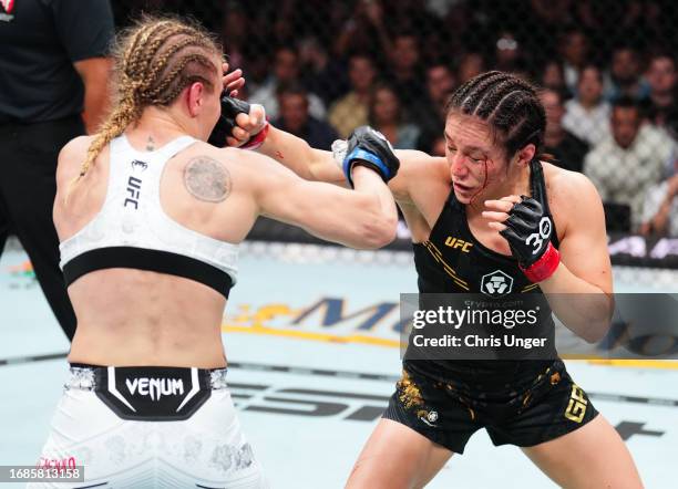 Alexa Grasso of Mexico punches Valentina Shevchenko of Kyrgyzstan in the UFC flyweight championship fight during the Noche UFC event at T-Mobile...