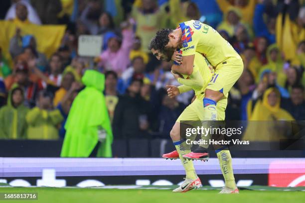 Diego Valdes of America celebrates with Igor Lichnovsky of America after scoring the team's third goal during the 8th round match between America and...