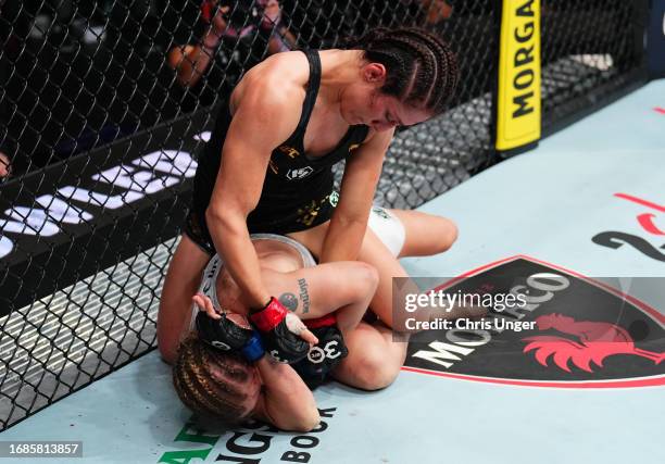 Alexa Grasso of Mexico punches Valentina Shevchenko of Kyrgyzstan in the UFC flyweight championship fight during the Noche UFC event at T-Mobile...