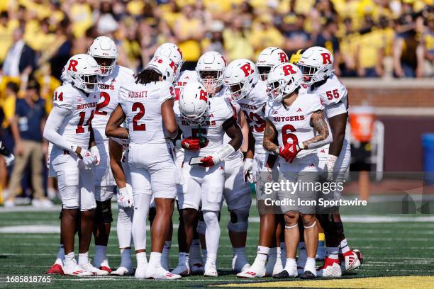 Rutgers Scarlet Knights players huddle before a play during a college football game against the Michigan Wolverines on September 2023 at Michigan...