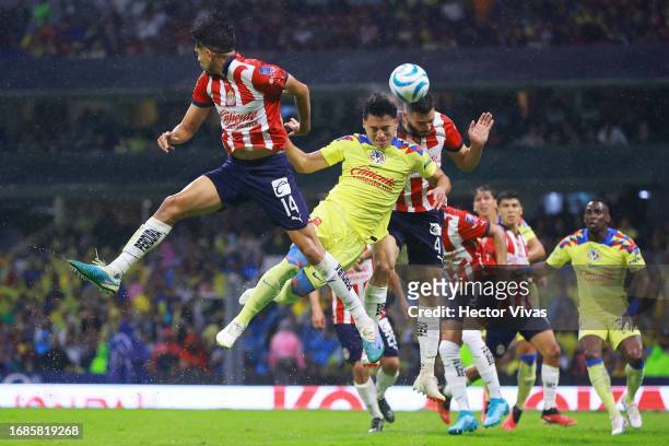 Ramon Juarez of America battles for possession with Ricardo Marin and Antonio Briseño of Chivas during the 8th round match between America and Chivas...