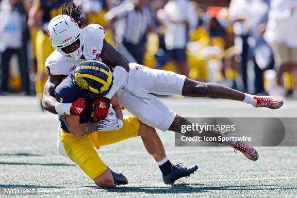 Rutgers Scarlet Knights defensive back Flip Dixon tackles Michigan Wolverines wide receiver Roman Wilson during a college football game on September...