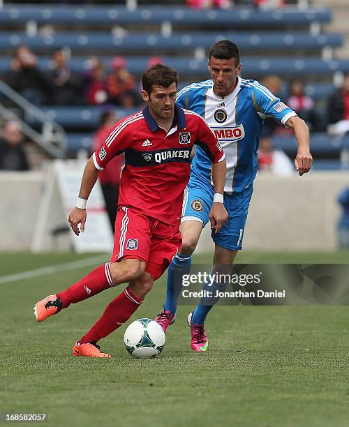 Gonzalo Segares of the Chicago Fire moves under pressure from Sebastien Le Toux of the Philadelphia Union during an MLS match at Toyota Park on May...