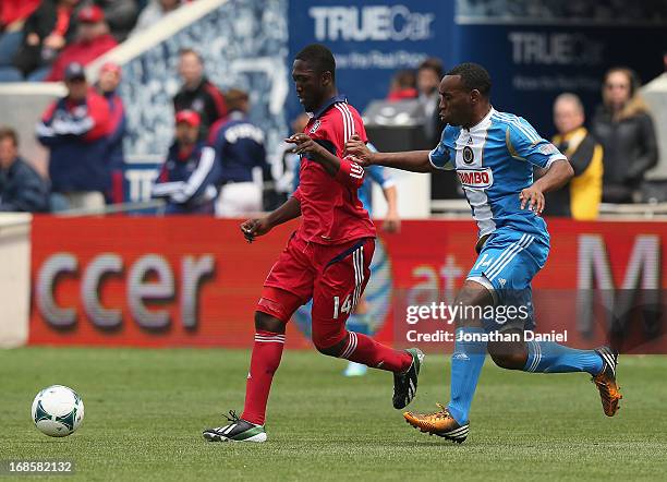 Patrick Nyarko of the Chicago Fire and Amobi Okugo of the Philadelphia Union chase the ball during an MLS match at Toyota Park on May 11, 2013 in...