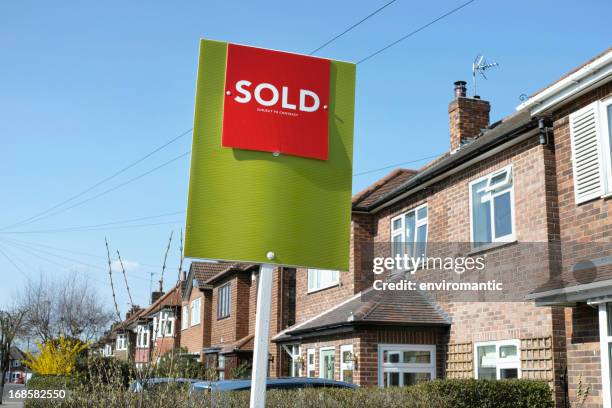 english suburban house with 'sold' sign. - sign shingle stock pictures, royalty-free photos & images