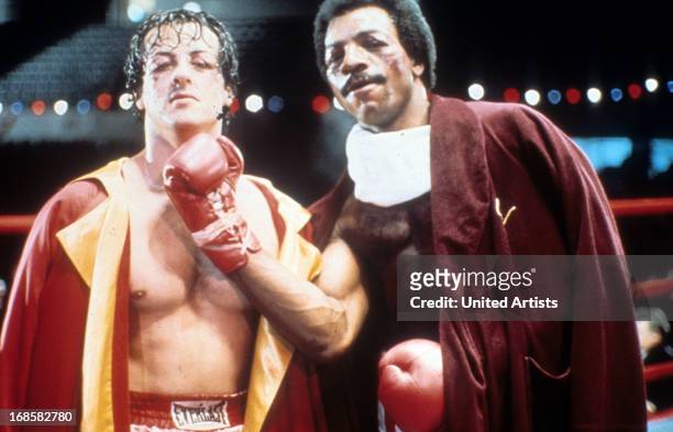 Sylvester Stallone and Carl Weathers on set of the film 'Rocky', 1976.