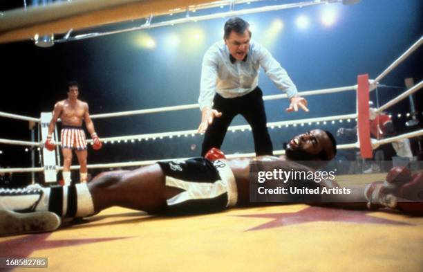 Sylvester Stallone watches as Carl Weathers falls in a scene from the film 'Rocky III', 1982.