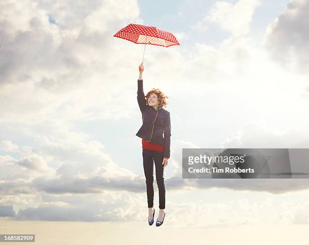 young woman flying with umbrella. - safety funny fotografías e imágenes de stock