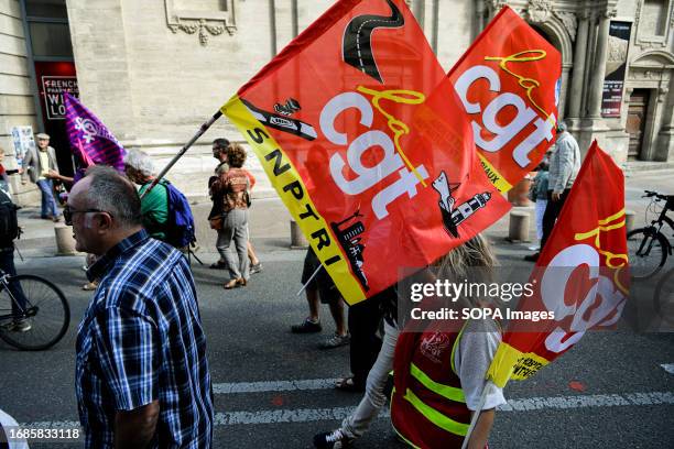 Protesters are seen holding a CGT flag during the march. Approximately one hundred people gathered in Avignon, joining nationwide protests across a...