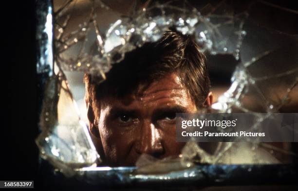 Harrison Ford looks through broken glass in a scene from the film 'Indiana Jones And The Temple Of Doom', 1984.