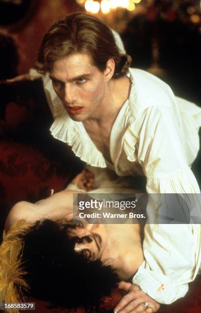 Tom Cruise leans over a victim in a scene from the film 'Interview With The Vampire: The Vampire Chronicles', 1994.