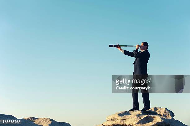 businessman looking to the future with telescope - telescopes stock pictures, royalty-free photos & images