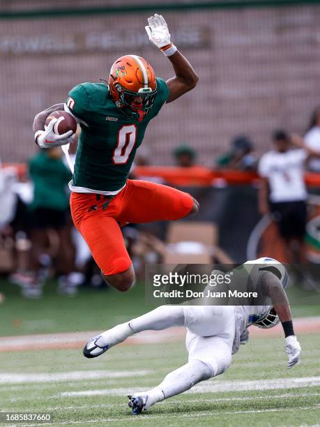 Tight End Jeremiah Pruitte of the Florida A&M Rattlers leaps over Linebacker Ralph Ortiz of the West Florida Argonauts during the game at Bragg...