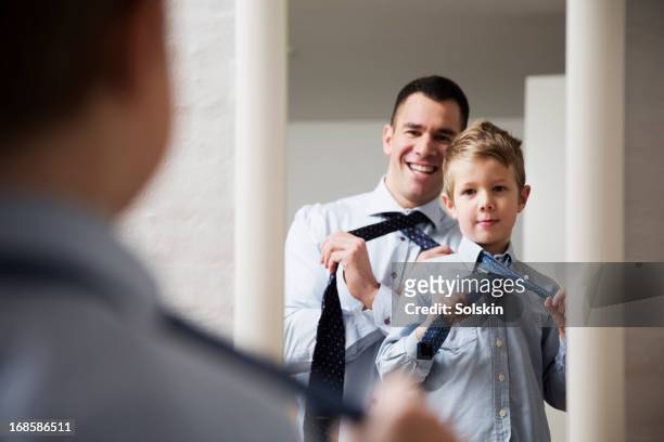 father teaching son to tie a tie - tie bildbanksfoton och bilder
