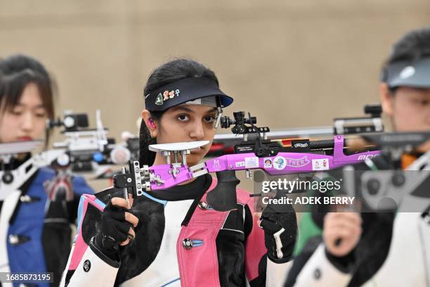 China's Han Jiayu , India's Ramita, China's Huang Yuting compete in the final of the women's 10m Air Rifle during the Hangzhou 2022 Asian Games in...