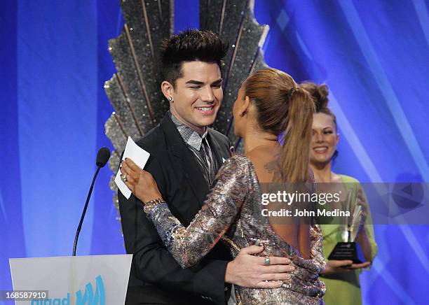 Adam Lambert hugs Melanie brown, aka Mel B, after accepting the 2013 Davidson/Velentini Award for oustanding music artist during the 24th Annual...