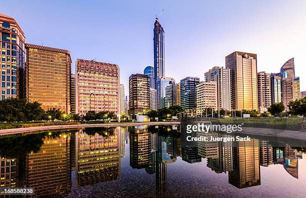 abu dhabi downtown skyline and corniche reflections - abu dhabi stock pictures, royalty-free photos & images