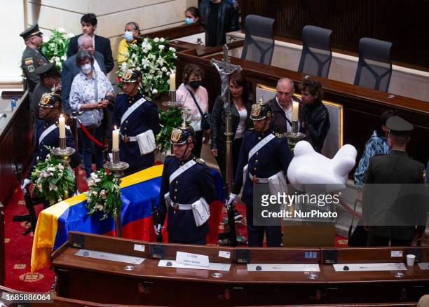 People attend the tribute at the National Capitol for Master Fernando Botero, where the master's casket and the peace dove, a sculpture created by...