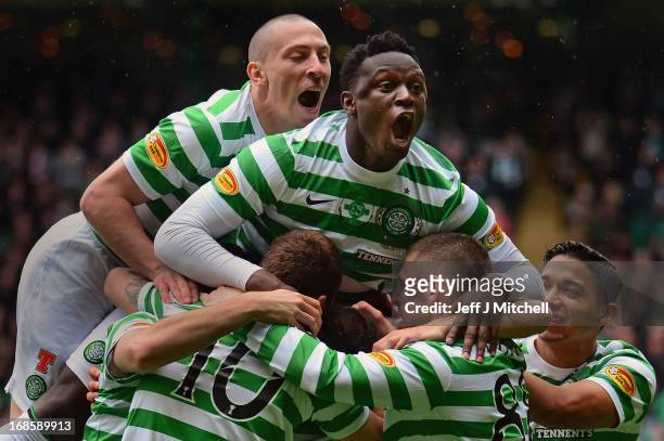 Joe Ledley of Celtic is joined by Scott Brown and Victor Wanyama as he celebrates after scoring the opening goal with his team-mates during the...