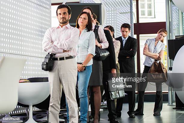 waiting in line - medium group of people stock pictures, royalty-free photos & images