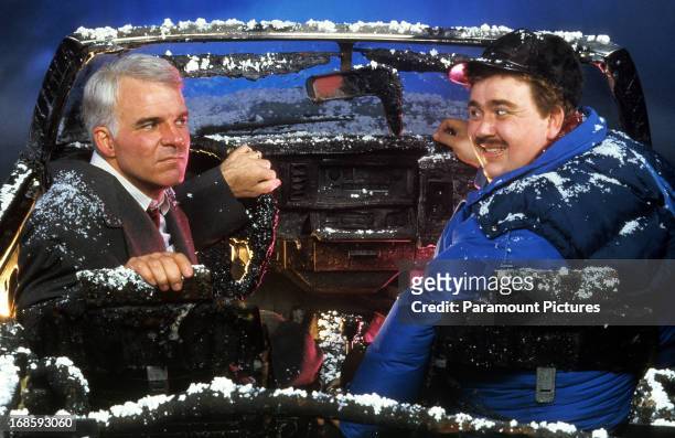 Steve Martin and John Candy sit in a destroyed car in a scene from the film 'Planes, Trains & Automobiles', 1987.