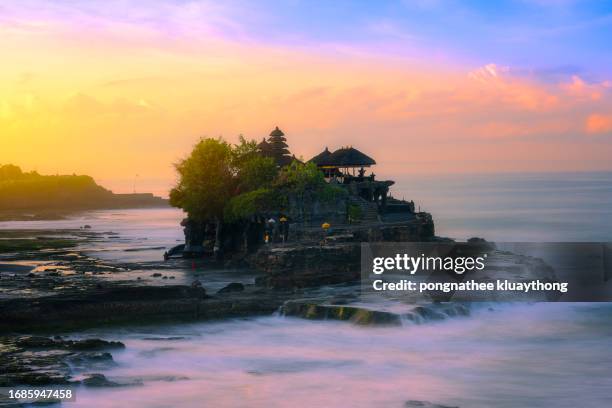 a beautiful color of sunrise at tanah lot, bali, indonesia. - bali stock pictures, royalty-free photos & images