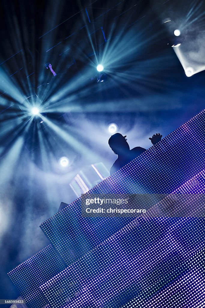 A silhouette of a DJ at a club