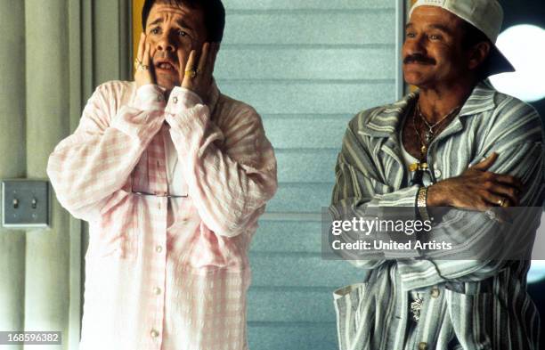 Nathan Lane and Robin Williams standing in pajamas on the porch in a scene from the film 'The Birdcage', 1996.