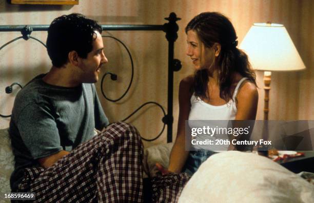Paul Rudd and Jennifer Aniston talking on bed in a scene from the film 'The Object Of My Affection', 1998.