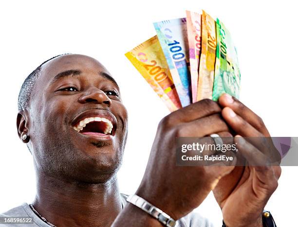 delighted man holds sheaf of new south african banknotes - am rand stock pictures, royalty-free photos & images