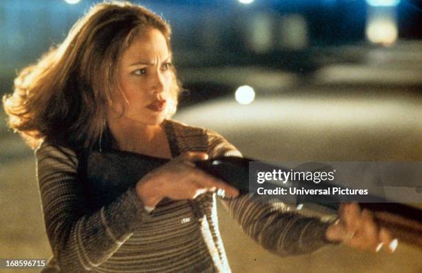 Jennifer Lopez holding rifle in a scene from the film 'Out Of Sight', 1998.